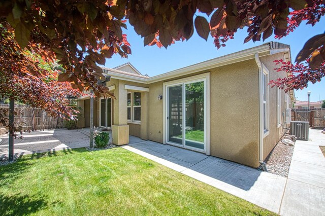 back of house with stucco siding, a patio, and cooling unit