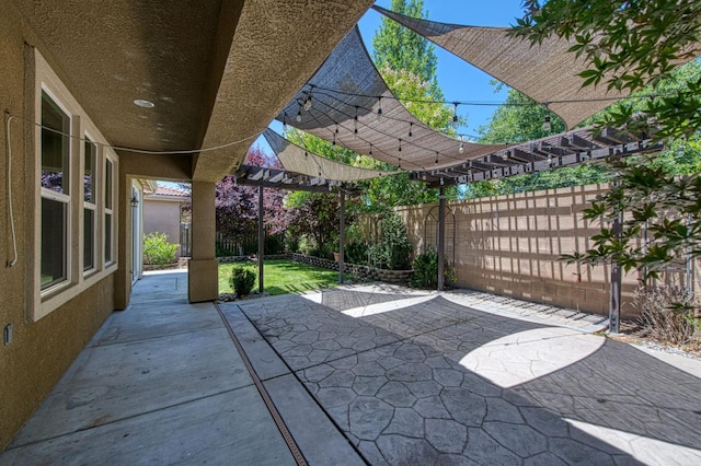 fenced backyard with a patio area