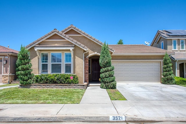 ranch-style home featuring a garage, concrete driveway, stucco siding, a front yard, and a tiled roof