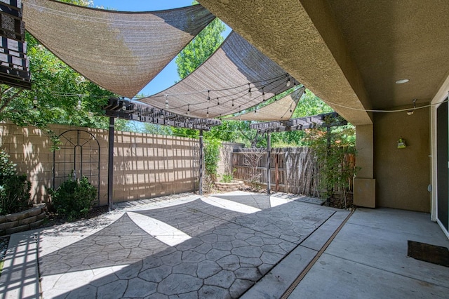 fenced backyard featuring a pergola and a patio