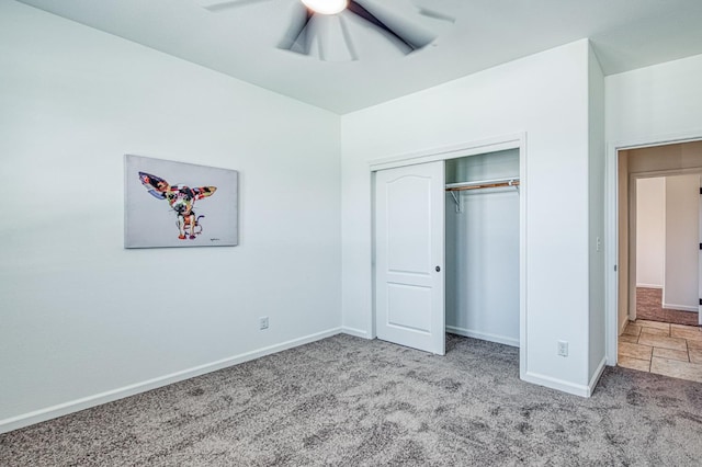 unfurnished bedroom with carpet, baseboards, a closet, and ceiling fan