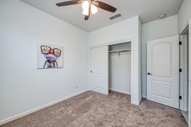 unfurnished bedroom with light colored carpet, baseboards, a closet, and a ceiling fan