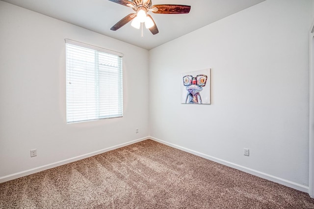 spare room featuring carpet floors, a ceiling fan, and baseboards