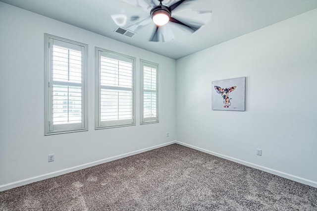carpeted empty room with plenty of natural light, baseboards, and a ceiling fan