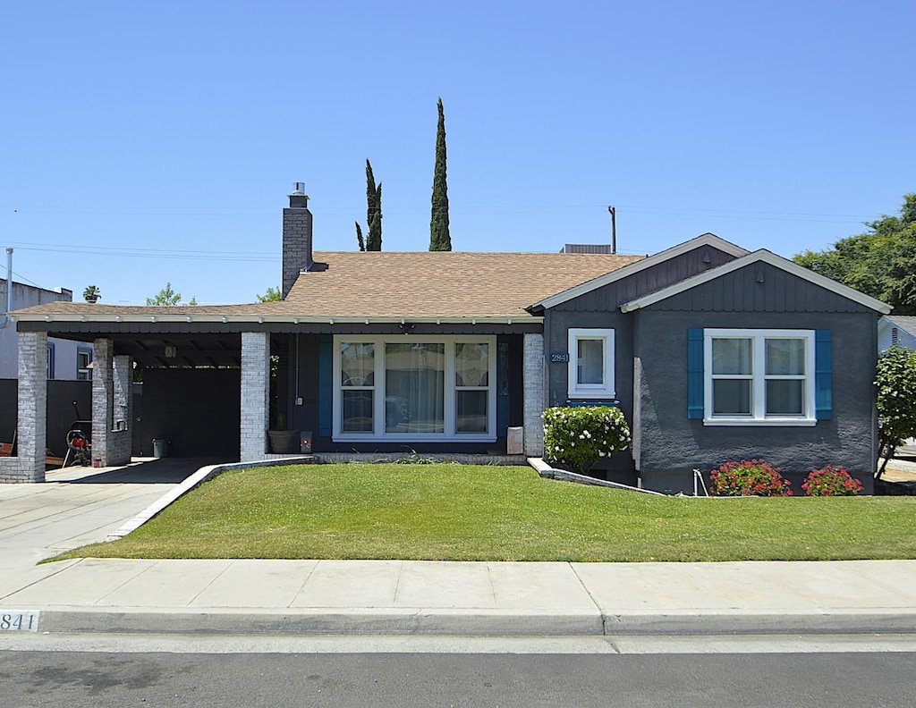 2841 C St, Selma, CA 93662 - ranch-style house with a chimney, a front yard, driveway, an attached carport, and roof with shingles