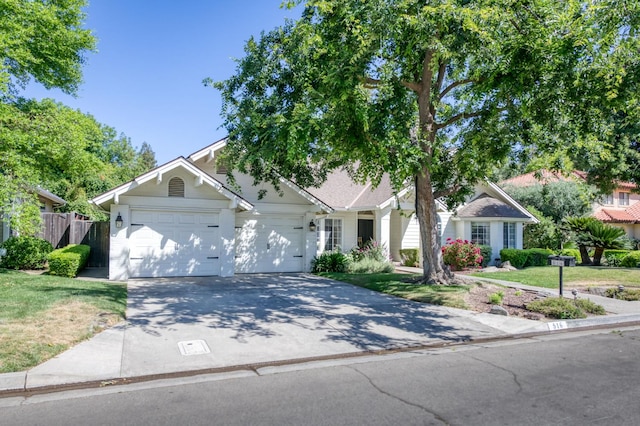 obstructed view of property featuring an attached garage and concrete driveway