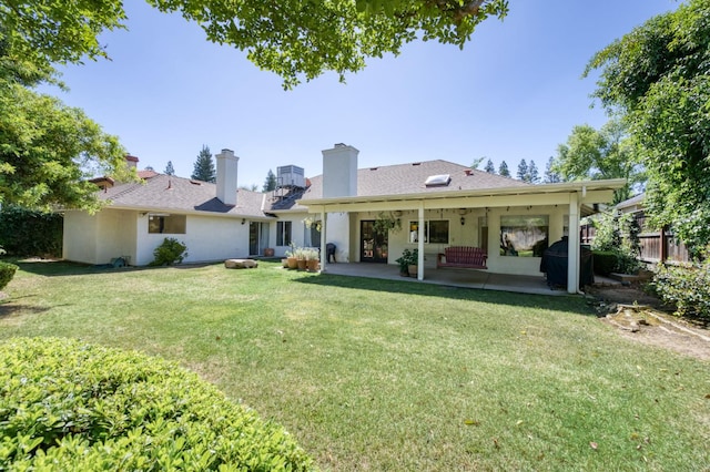 rear view of property with a patio area and a chimney