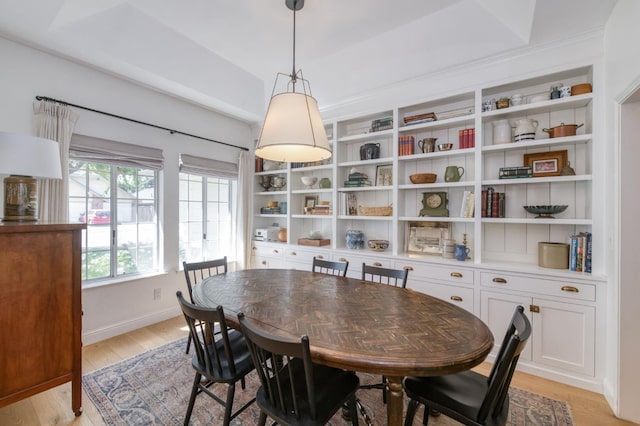 dining space with light wood-style floors and baseboards