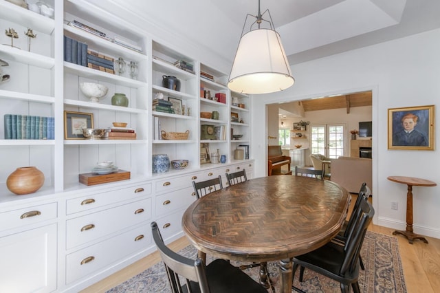 dining room with light wood-type flooring and baseboards