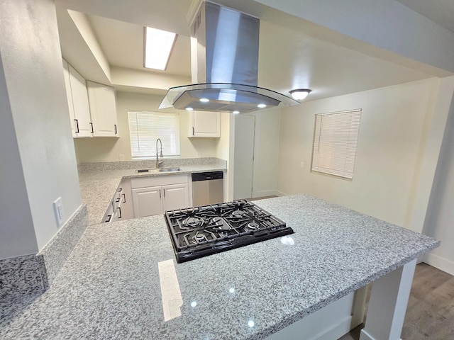 kitchen with island exhaust hood, a sink, dishwasher, cooktop, and light stone countertops