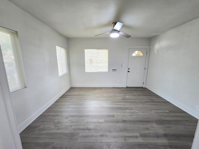 entrance foyer with a ceiling fan, wood finished floors, and baseboards