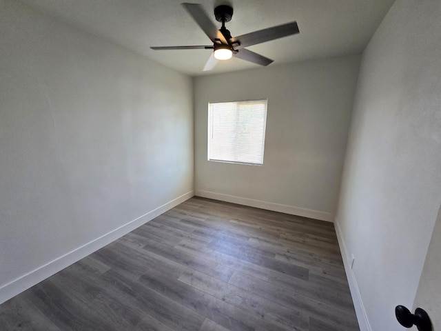 empty room with a ceiling fan, baseboards, and dark wood finished floors