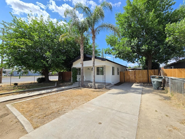 bungalow-style home featuring stucco siding and driveway