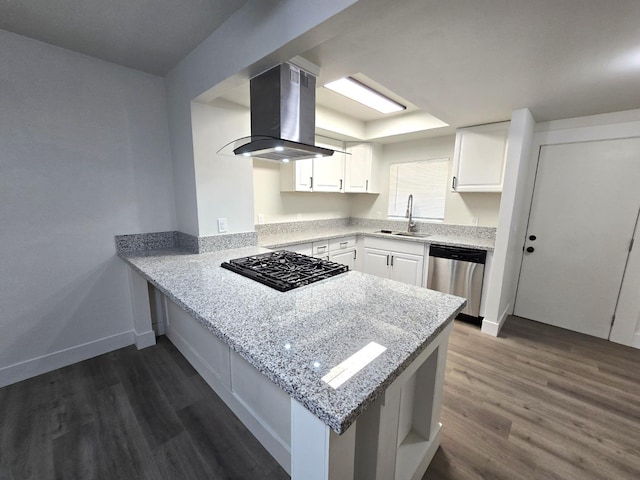 kitchen with island exhaust hood, dishwasher, black gas stovetop, a peninsula, and dark wood finished floors