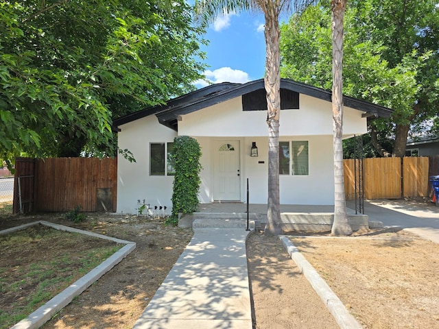 view of front facade featuring stucco siding and a porch