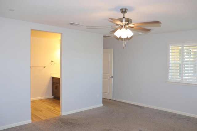 1884 Clover, Dinuba, CA 93618 - unfurnished bedroom with light carpet, baseboards, connected bathroom, and a ceiling fan