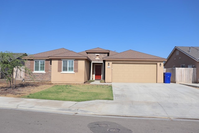 1884 Clover, Dinuba, CA 93618 - view of front of property featuring stone siding, an attached garage, stucco siding, and driveway