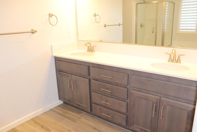1884 Clover, Dinuba, CA 93618 - bathroom with wood finished floors, double vanity, a shower stall, and baseboards