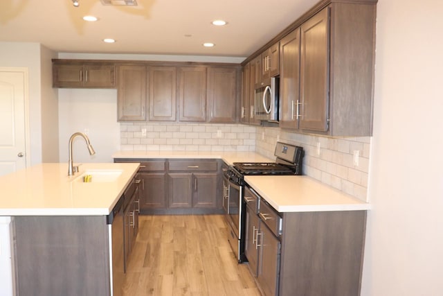 1884 Clover, Dinuba, CA 93618 - kitchen featuring stainless steel appliances, a sink, light wood finished floors, light countertops, and recessed lighting