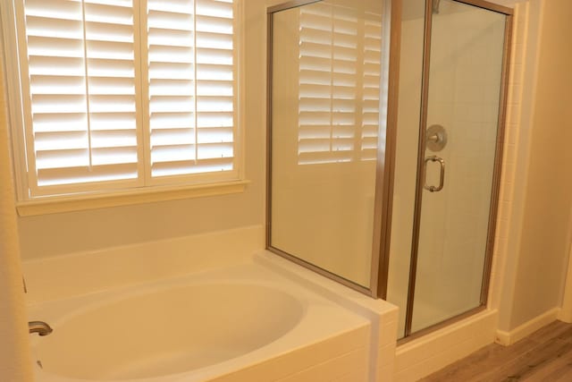 1884 Clover, Dinuba, CA 93618 - bathroom featuring a shower stall, a garden tub, and wood finished floors