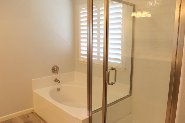 1884 Clover, Dinuba, CA 93618 - full bath with a bath, a shower stall, and wood finished floors