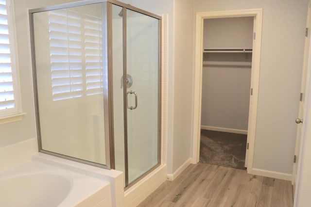 1884 Clover, Dinuba, CA 93618 - full bathroom with wood finished floors, a stall shower, a walk in closet, and a garden tub