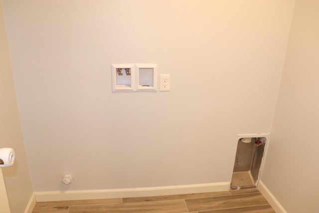 1884 Clover, Dinuba, CA 93618 - laundry room featuring light wood-type flooring, baseboards, and hookup for a washing machine