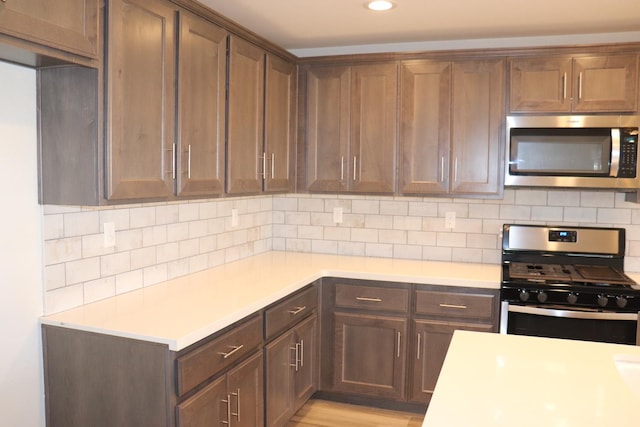 1884 Clover, Dinuba, CA 93618 - kitchen with appliances with stainless steel finishes, light countertops, decorative backsplash, and recessed lighting