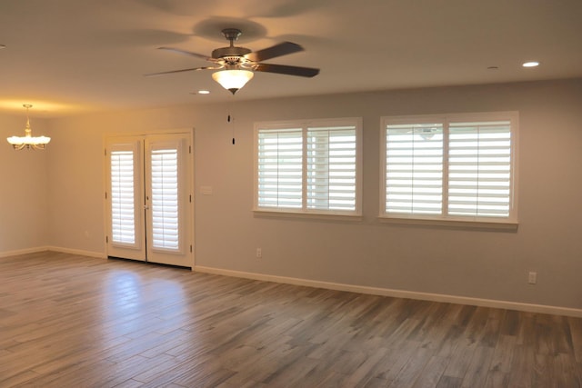 1884 Clover, Dinuba, CA 93618 - empty room featuring a chandelier, wood finished floors, baseboards, ceiling fan, and recessed lighting