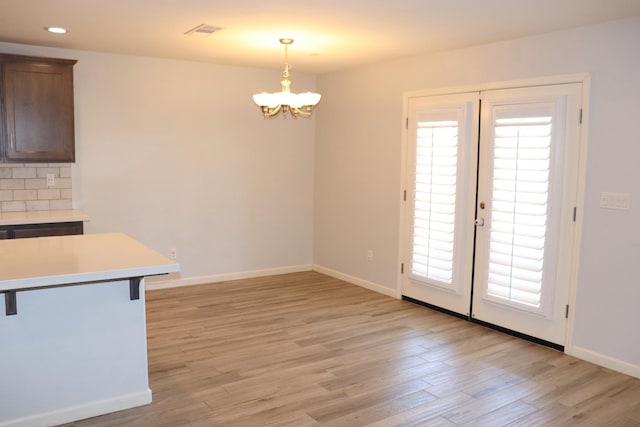1884 Clover, Dinuba, CA 93618 - unfurnished dining area featuring light wood finished floors, a chandelier, baseboards, and recessed lighting