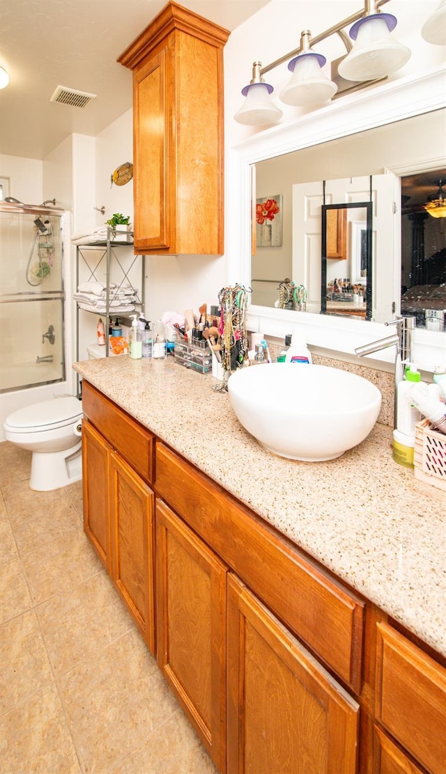 45704 Butternut Ln, Yokuts Valley, CA 93675 - full bath with vanity, tile patterned flooring, toilet, and bath / shower combo with glass door
