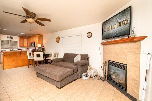 45704 Butternut Ln, Yokuts Valley, CA 93675 - living room with a ceiling fan, a fireplace, and light tile patterned flooring