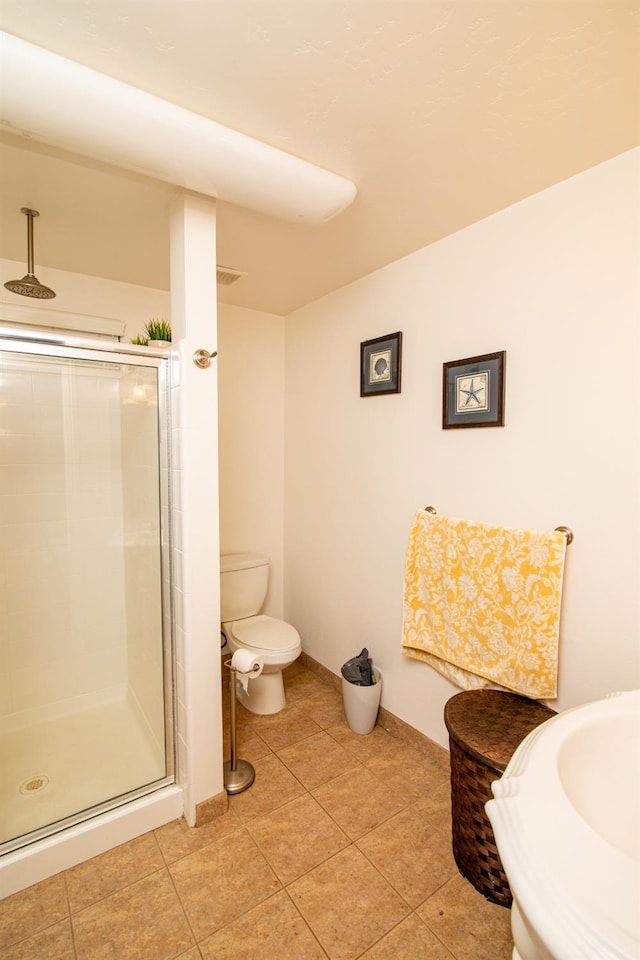 45704 Butternut Ln, Yokuts Valley, CA 93675 - bathroom with a stall shower, toilet, and tile patterned floors