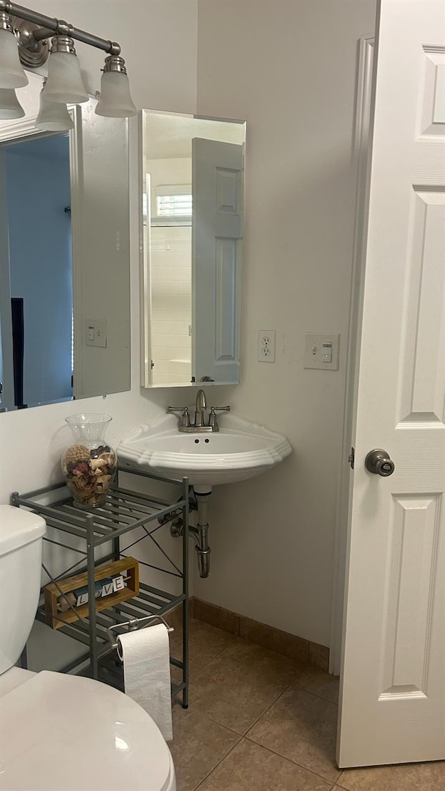 45704 Butternut Ln, Yokuts Valley, CA 93675 - bathroom featuring toilet, tile patterned floors, baseboards, and a sink