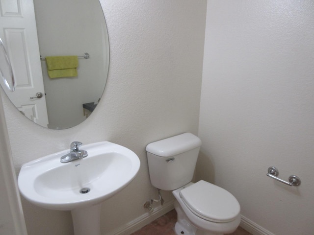 1016 Papaya St, Madera, CA 93638 - half bath with a sink, toilet, and baseboards