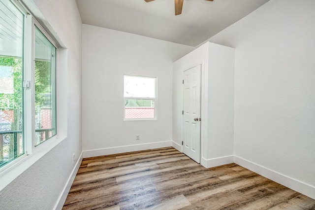 604 N Poplar Ave, Fresno, CA 93728 - unfurnished room with healthy amount of natural light, a ceiling fan, and wood finished floors
