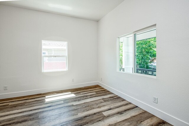 604 N Poplar Ave, Fresno, CA 93728 - empty room with healthy amount of natural light, wood finished floors, and baseboards