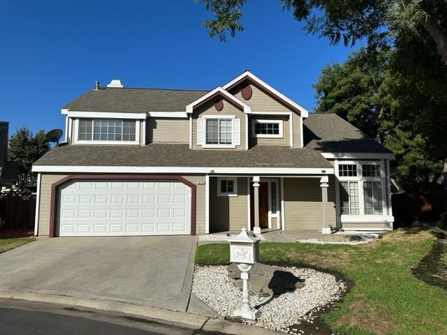 10752 N Windham Bay Cir, Fresno, CA 93730 - view of front of property with concrete driveway, a garage, and a front lawn