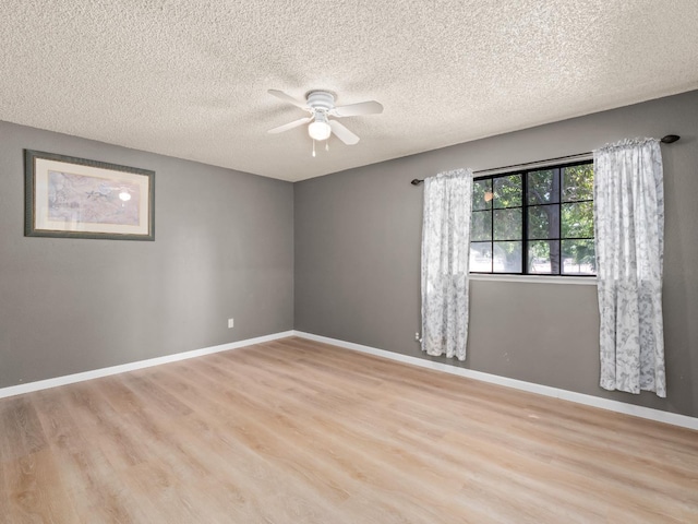 12502 Rd 37 Unit 1/2, Madera, CA 93636 - unfurnished room featuring a ceiling fan, light wood finished floors, a textured ceiling, and baseboards