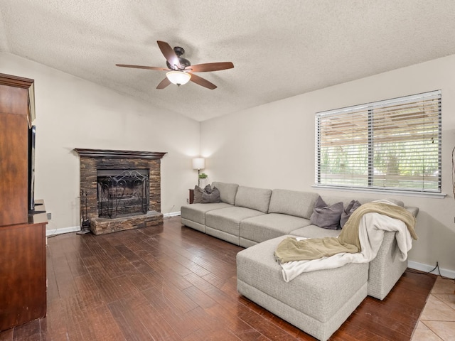 12502 Rd 37 Unit 1/2, Madera, CA 93636 - living area with ceiling fan, a textured ceiling, a stone fireplace, vaulted ceiling, and wood finished floors