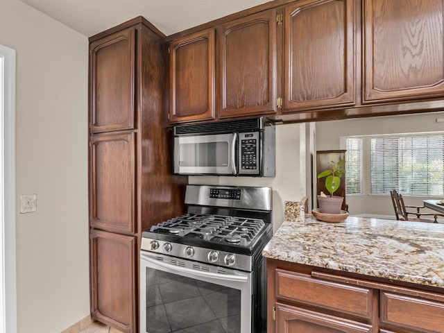 12502 Rd 37 Unit 1/2, Madera, CA 93636 - kitchen featuring appliances with stainless steel finishes, light stone counters, and light tile patterned floors