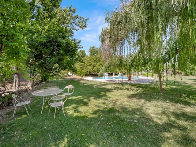 12502 Rd 37 Unit 1/2, Madera, CA 93636 - view of green lawn featuring an outdoor pool