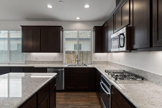 3822 Hannah Ln, Clovis, CA 93619 - kitchen with stainless steel appliances, a sink, dark brown cabinets, plenty of natural light, and recessed lighting