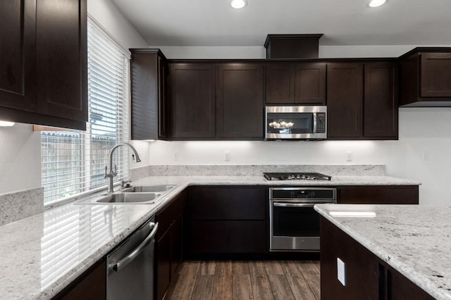 3822 Hannah Ln, Clovis, CA 93619 - kitchen featuring stainless steel appliances, a sink, dark brown cabinetry, dark wood-type flooring, and recessed lighting
