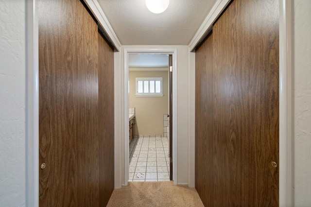 1322 W Millbrae Ave, Fresno, CA 93711 - corridor with light carpet, light tile patterned floors, and a textured ceiling
