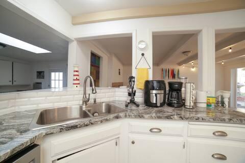 5543 N 7th St, Fresno, CA 93710 - kitchen featuring a sink, white cabinets, light stone countertops, and dishwasher
