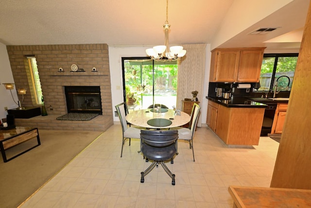 6340 N Gilroy Ave, Fresno, CA 93722 - dining area featuring a fireplace, a chandelier, light flooring, and lofted ceiling