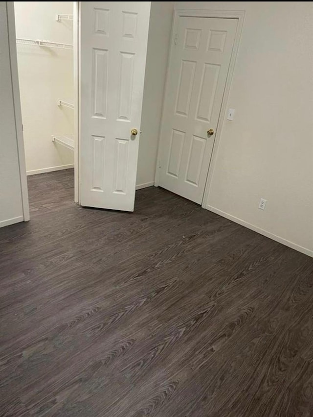 5323 W Garland Ave, Fresno, CA 93722 - unfurnished bedroom featuring dark wood finished floors, baseboards, and a closet