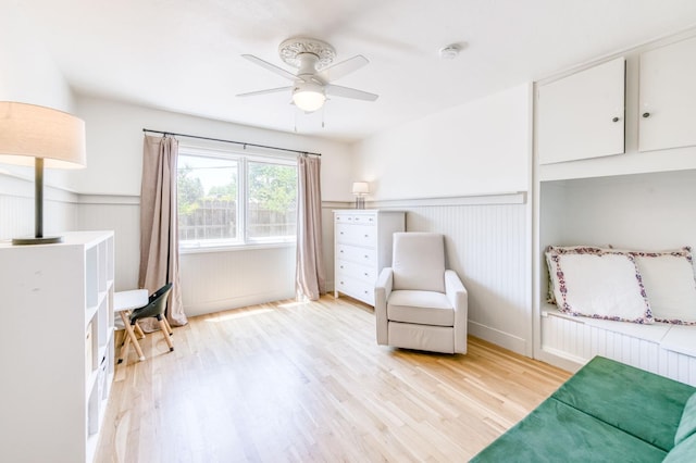 5669 N Arthur Ave, Fresno, CA 93711 - living area with light wood finished floors, ceiling fan, and a wainscoted wall