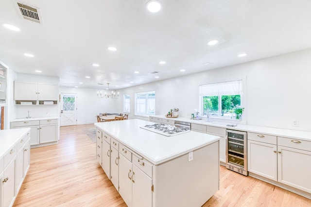 5669 N Arthur Ave, Fresno, CA 93711 - kitchen featuring wine cooler, a chandelier, a center island, recessed lighting, and light countertops